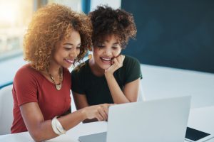 Shot of two young designers working on a laptop together